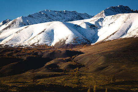 Snow-capped peaks of the North Chuya Range and foothills in the deep autumn of the Altai Republic, Russia.の写真素材