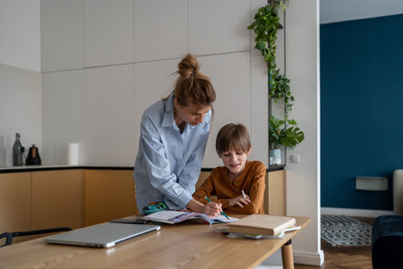 Happy child boy learning foreign language with private teacher tutor at homeの写真素材