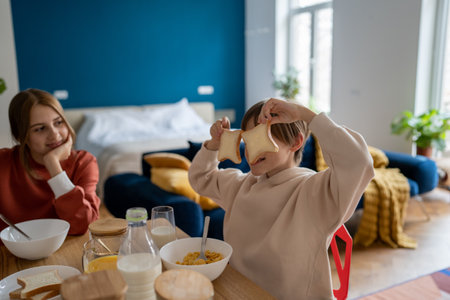 Happy smiling kids brother and children having fun while having breakfastの写真素材
