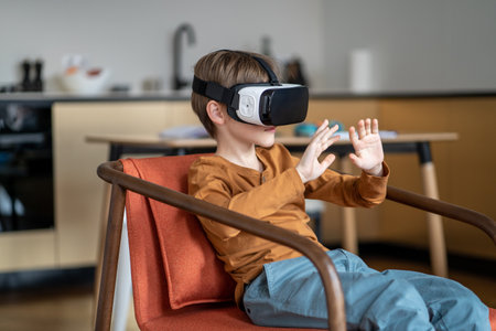 Child boy in VR headset device interacting with 3D world