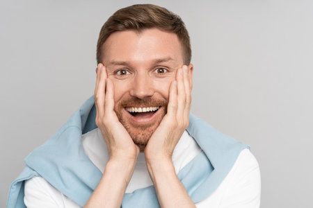 Smiling handsome man with mouth open. Excited guy getting amazed of positive news. Closeup face.の写真素材