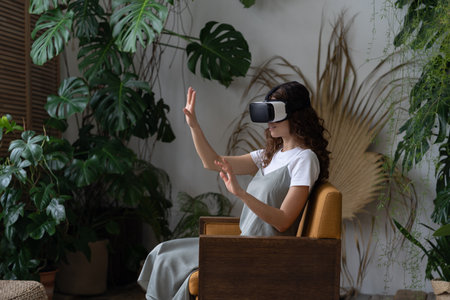 Happy girl in vr glasses touch interactive screen virtual reality for entertainment at home garden
