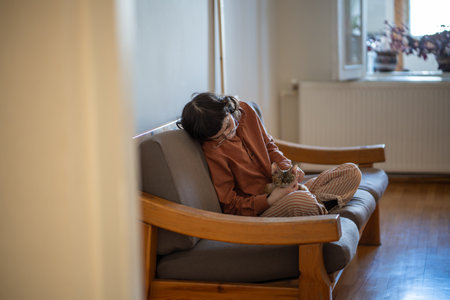 Depressed pet owner feeling lonely, stressed sitting at home with friend, companion cat devon rexの写真素材