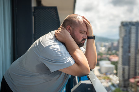 Man puffs suffers from abnormal heat. Guy tired of hot summer weather dying of severe sweatingの写真素材