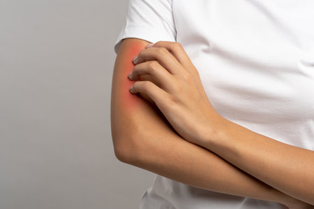 Red arm of person with allergic reaction, scratching itching skin, requiring dermatologist therapy