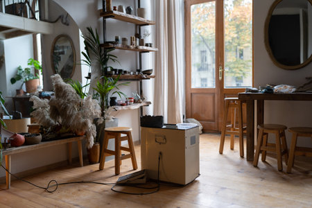 Cozy home pottery studio or ceramics workshop with handmade products on shelvesの写真素材