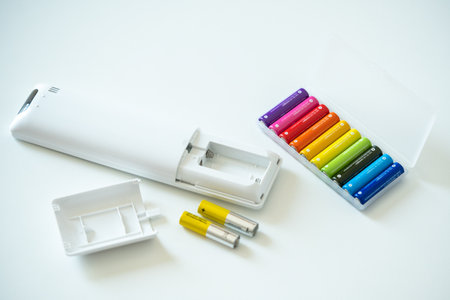 New colorful AAA battery in plastic box for tv remote control and old used batteries