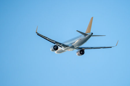 Passenger airplane flight in blue sky bottom view. Travel concept.