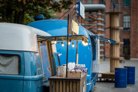 Hot dog van and coffee take away on city street, mobile food truck. Cafe in van with menu outdoors