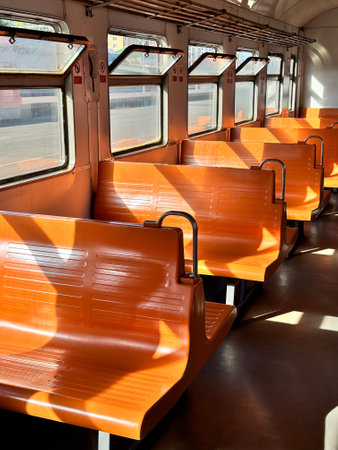Vintage electric train car with orange seats, interior design. Retro transportation style, road tripの写真素材