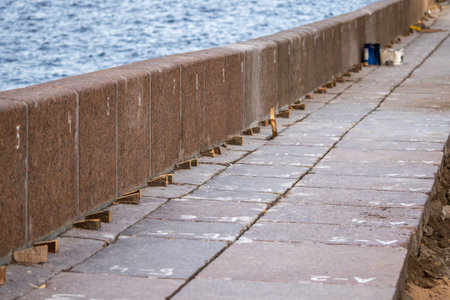 Embankment repair on Neva river strengthens and aligns granite slabs. Granite support on waterfrontの写真素材