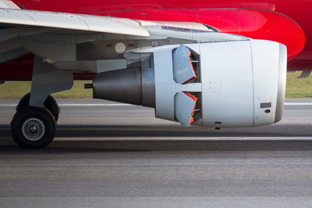 Narrow-body airplane engine in reverse closeup, side view. Backward thrust of the aircraft engine