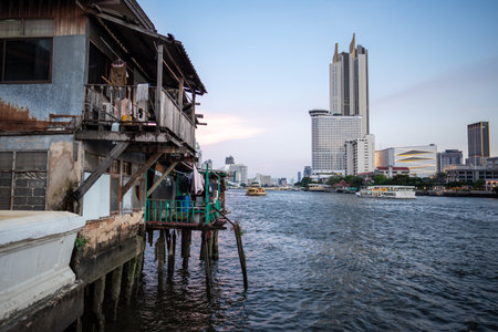 Bangkoks contrasts: poverty and slums against skyscrapers and business centers on two riverbanks.の写真素材