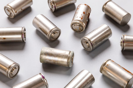 spent used rechargeable Nickel Metal Hydride (Ni-MH) battery, grey background, flat layの写真素材