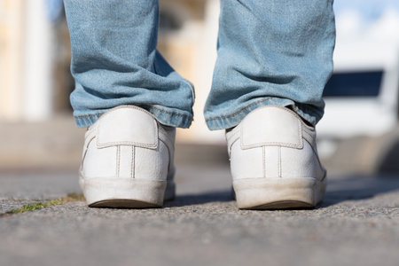 Irregular wear heel male shoes, closeup back view. Flat feet and fast wear of shoes