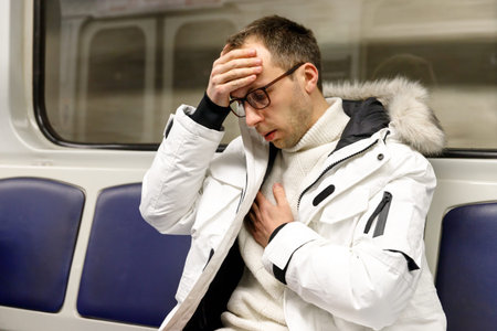 man in subway train has problems with breathing, pressure