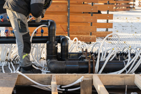 Worker building pipeline system for low temperature maintenance. Preparing of outdoor skating rink