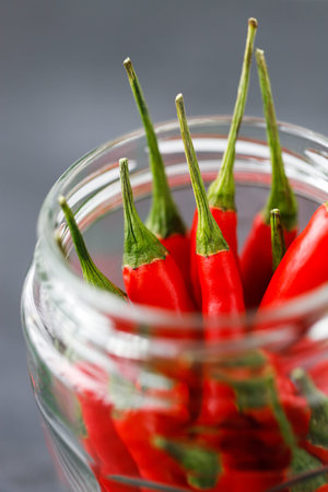 red hot chilli peppers in glass vintage jar