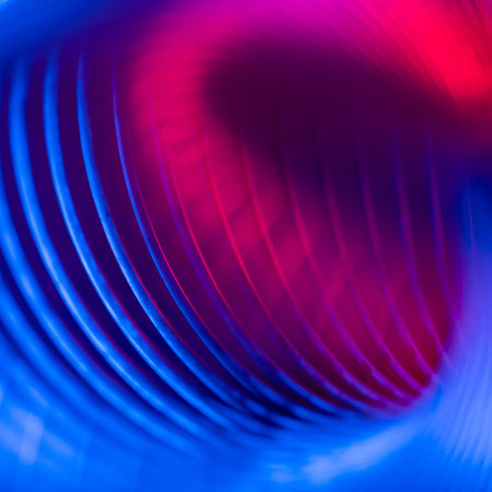 Closeup of coiled metal spring with sufficiently high strength and elastic properties in neon light