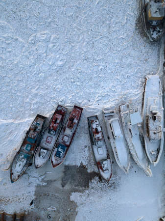Aerial photo of ships in frozen Baikal lake in winter. Snow around and above ships. Olkhon island.の写真素材