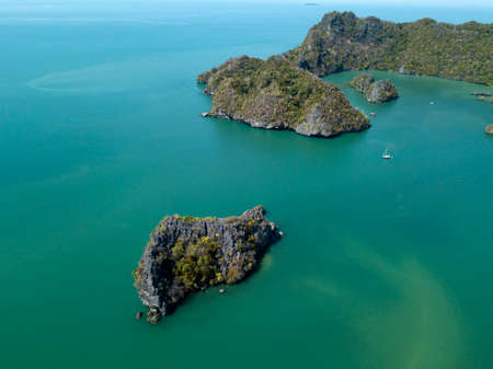 Lonely little islands in ocean, sea. Image on drone. Park Kilim Geoforest. Langkawi, Malaysia.