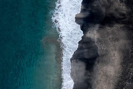 White and black sand Virgin Beach, blue sea coastline, white wave. Aerial view of Bali, Indonesia.