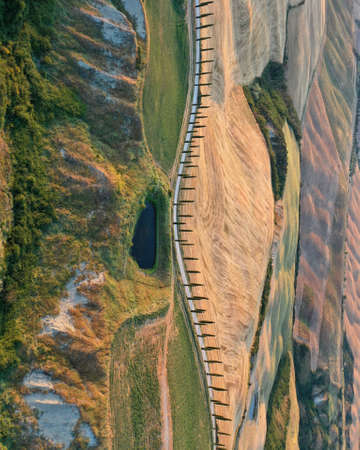 Abstract nature landscapes from drone, Tuscany, Italy. Road with cypress trees and pond.の写真素材