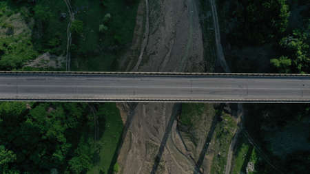 Aerial top down view of bridge over Aragvi river near Ananuri Fortress and Church. Mountain...