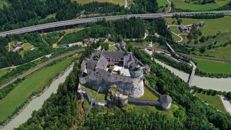 Aerial panoramic view of Hohenwerfen Castle, Austria. Medieval rock fortress in Alpine mountains with spruces. Overlooking the Werfen town in Salzach valley. Summer.のeditorial素材