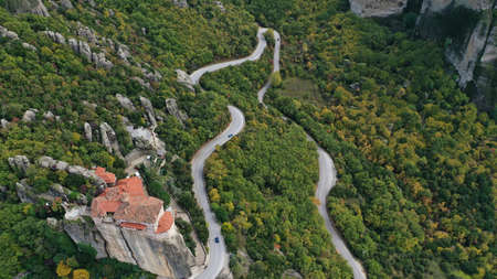 Aerial view of winding road near monastery on the cliff, Meteora mountains valley, Kalampaka, Greece.の写真素材