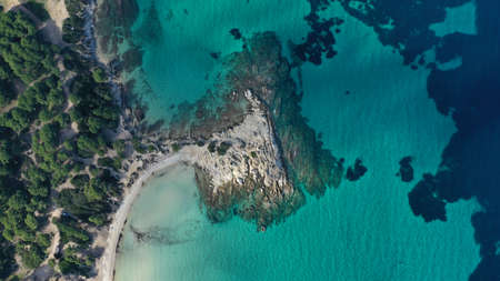 Aerial view of Vourvourou beach, small peninsula in turquoise water of Aegean sea. Waves beating...