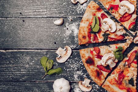 pizza cut beautifully on a rustic tableの写真素材