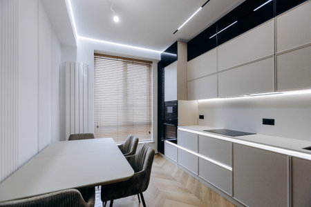 Explore the beauty of a Modern Minimalist Kitchen Interior Design complemented by a Dining Areaの写真素材