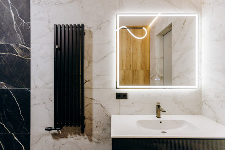 This is a modern bathroom that features elegant fixtures and a stylish design for comfortの写真素材