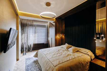 A Modern Bedroom featuring Elegant Lighting and Stylish Decor for ultimate comfortの写真素材
