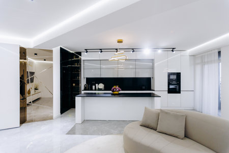 A cozy living room with a comfy couch and kitchen behindの写真素材