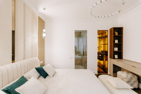 A beautifully designed bedroom with a large bed and walkin closetの写真素材