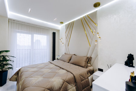 Cozy bedroom with a comfy bed, nightstand, and natural lightの写真素材