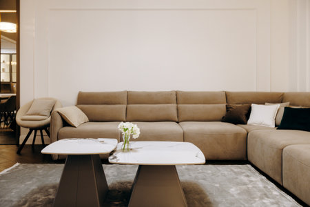 A cozy living room featuring a comfortable couch and two stylish coffee tablesの写真素材