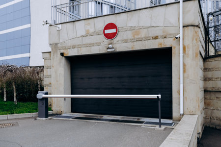 A black garage door that has a no entry sign clearly displayed on itの写真素材