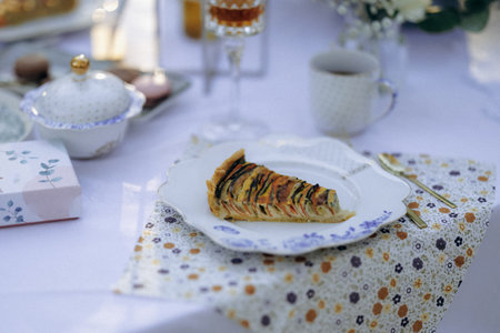 A delicious slice of pie is placed on a clean white plate on a tableの写真素材