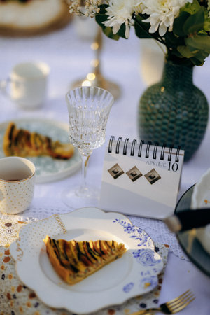 A delicious slice of pie positioned on a plate beside a calendarの写真素材