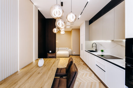 A kitchen with a dining table, chairs, and a couch in backgroundの写真素材