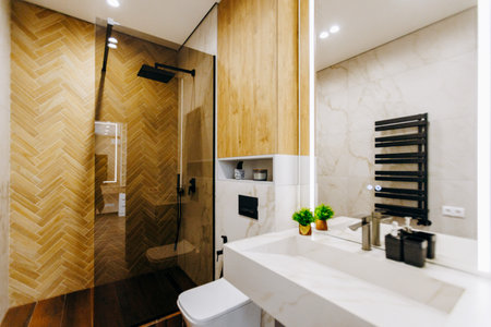 A spacious bathroom with a walkin shower, sink, toilet, and mirrorの写真素材