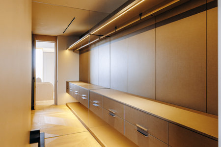 A spacious walkin closet featuring numerous drawers and shelves for storageの写真素材