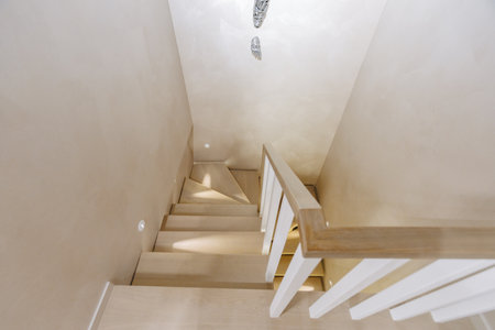 A staircase with a white railing leading to the second floorの写真素材