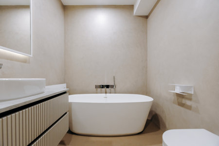 A bathroom with a bathtub, toilet, sink, and mirror for convenience