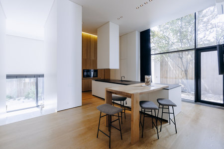 A beautiful kitchen with a black countertop and elegant white cabinetsの写真素材