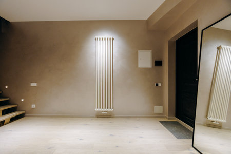 In the center of the room, there is a large, reflective mirrorの写真素材