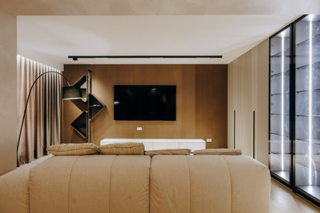 A cozy living room with a comfy couch and a wallmounted TVの写真素材